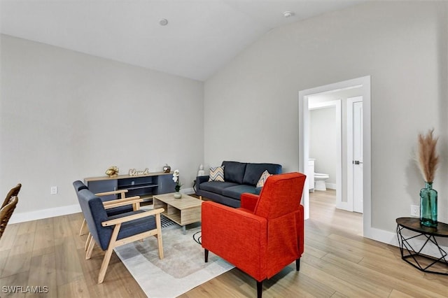 living room featuring light hardwood / wood-style flooring and lofted ceiling