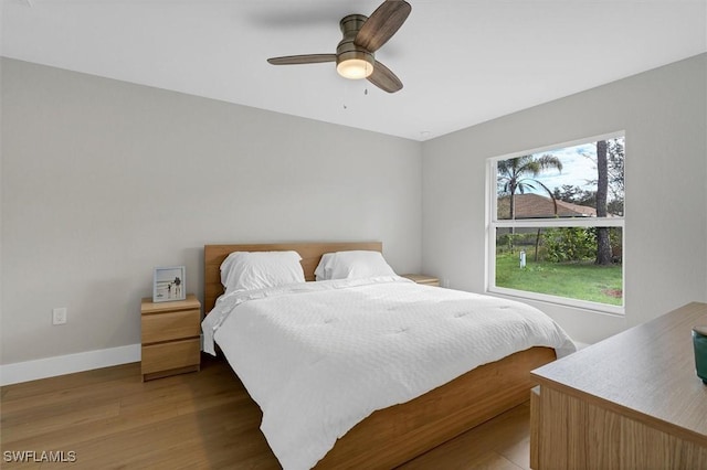 bedroom with ceiling fan and dark wood-type flooring