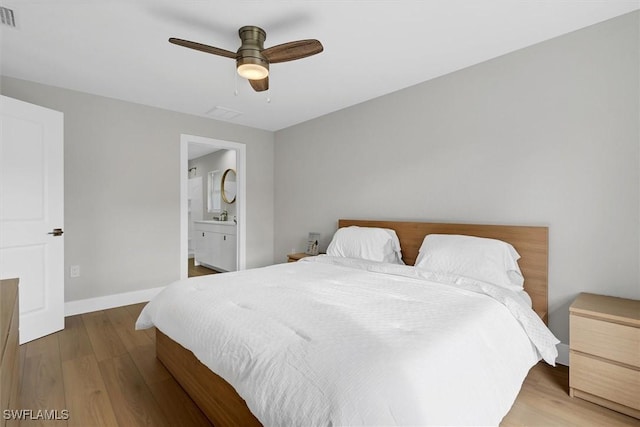 bedroom with ceiling fan, wood-type flooring, and ensuite bathroom