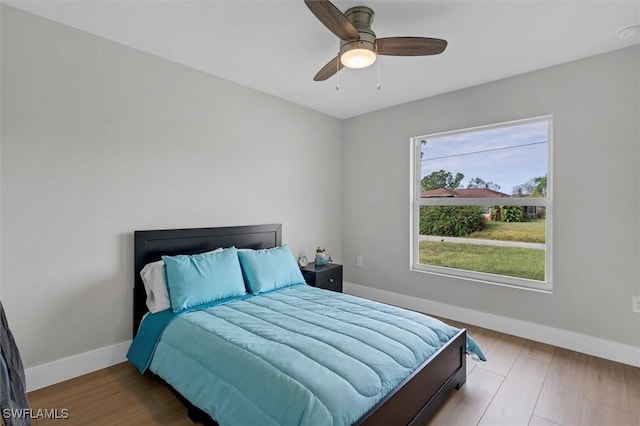 bedroom with ceiling fan and hardwood / wood-style flooring