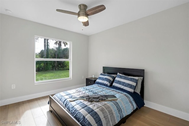 bedroom with hardwood / wood-style flooring and ceiling fan