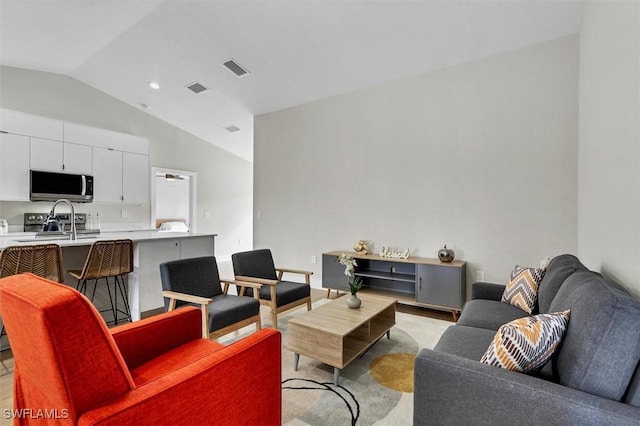 living room featuring lofted ceiling