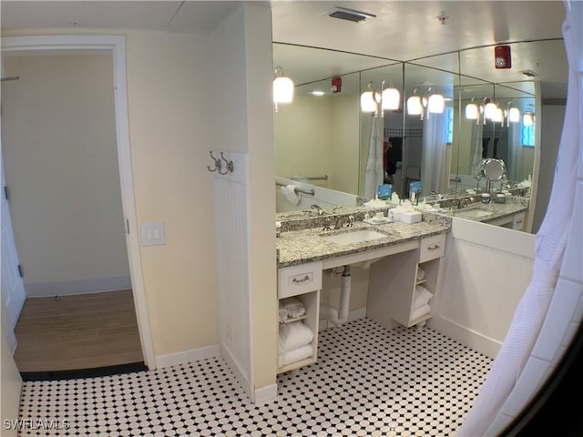 bathroom with tile patterned floors and vanity