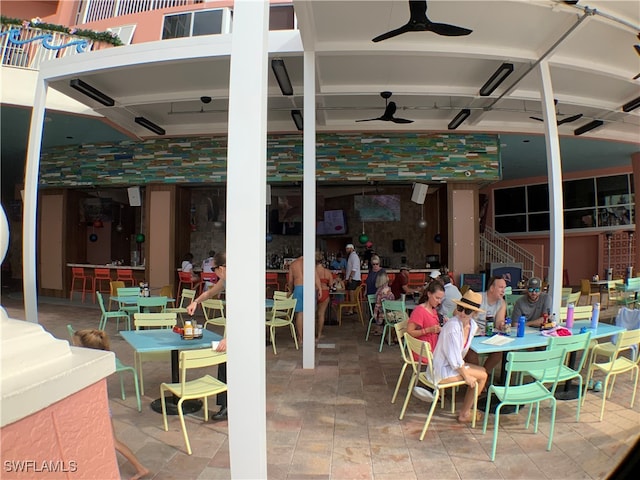 view of patio / terrace with ceiling fan and a bar