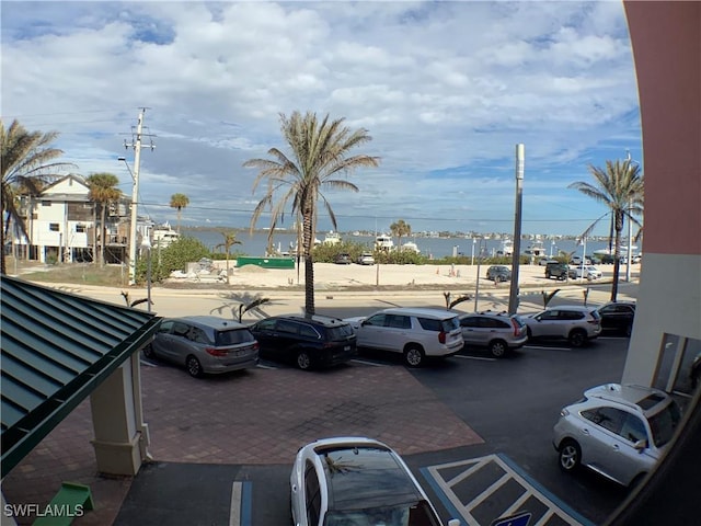 view of parking / parking lot featuring a water view