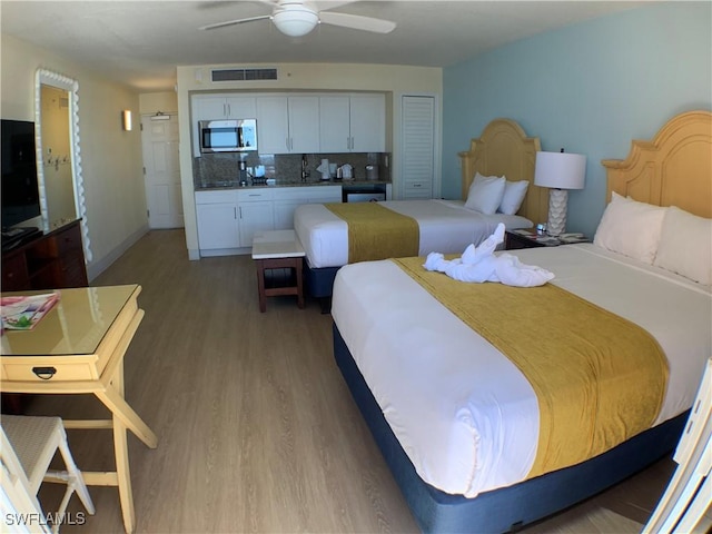 bedroom with hardwood / wood-style flooring and ceiling fan