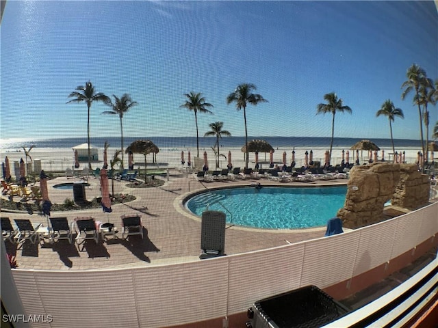 view of swimming pool featuring a water view