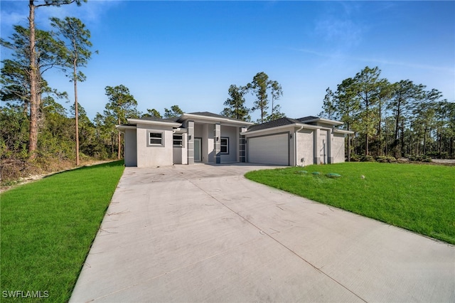 prairie-style house featuring a garage and a front lawn