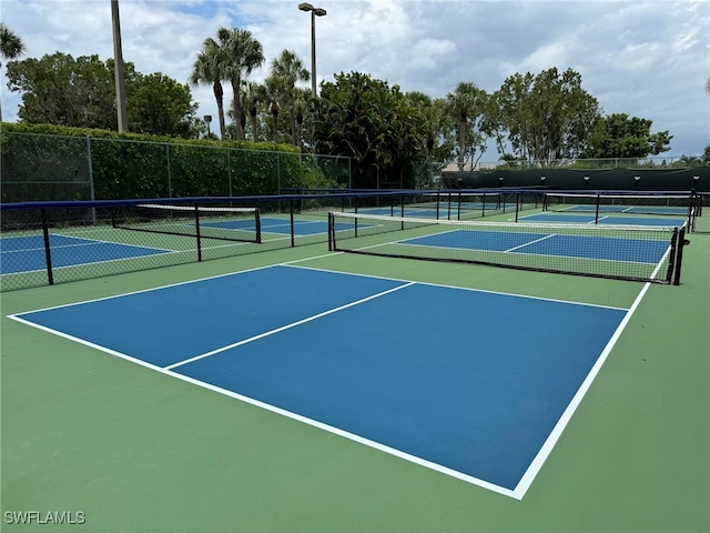 view of tennis court with basketball hoop