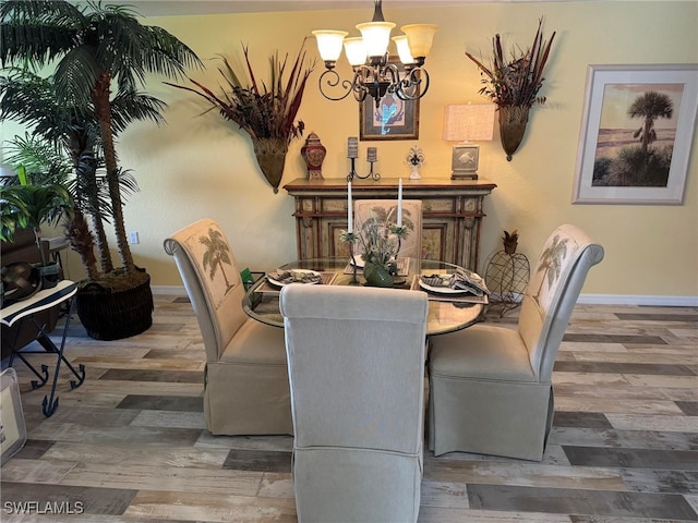 dining space featuring dark hardwood / wood-style flooring and a notable chandelier