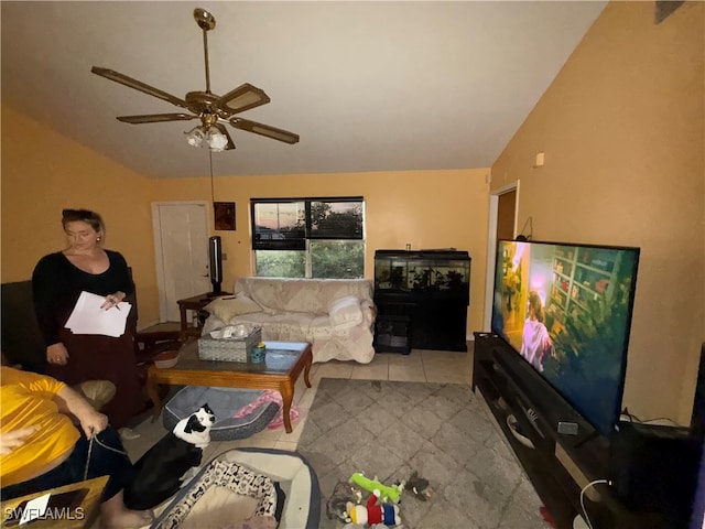 tiled living room featuring ceiling fan and vaulted ceiling