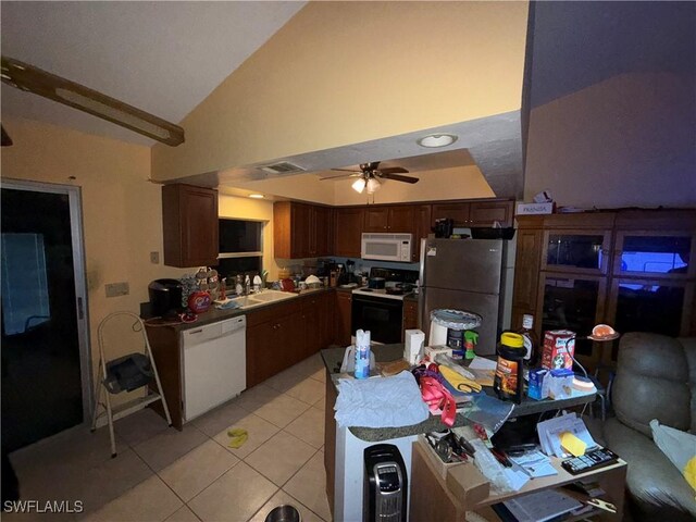 kitchen with white appliances, ceiling fan, sink, lofted ceiling, and light tile patterned flooring