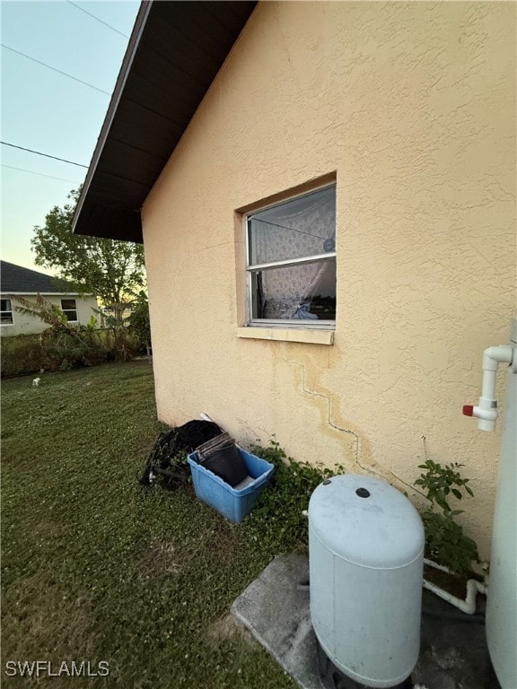 view of property exterior with a lawn