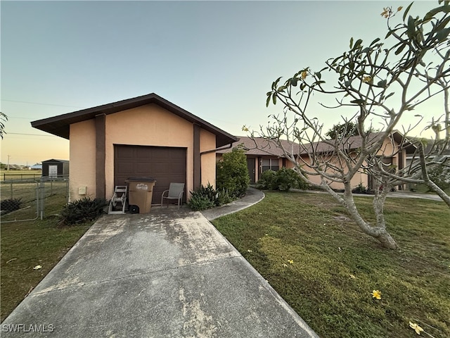 view of front of home featuring a garage and a yard