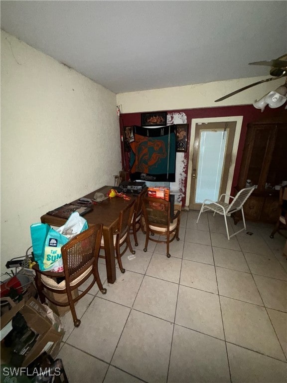 tiled dining area featuring ceiling fan