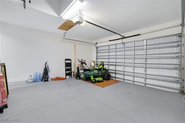 garage featuring a garage door opener and baseboards