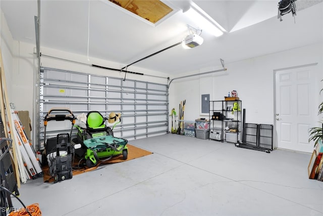 garage with a garage door opener and electric panel