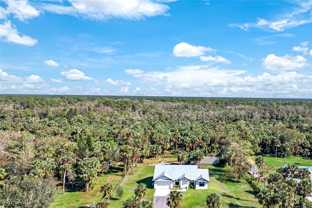 drone / aerial view with a wooded view