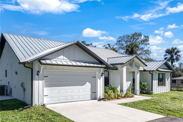 modern inspired farmhouse with a garage, a standing seam roof, board and batten siding, and concrete driveway