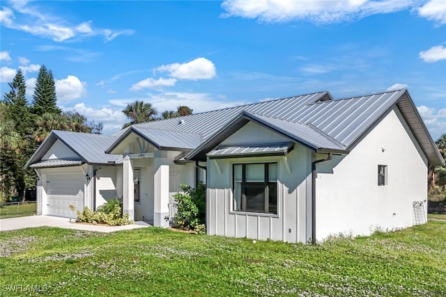 modern farmhouse featuring an attached garage, board and batten siding, metal roof, driveway, and a front lawn