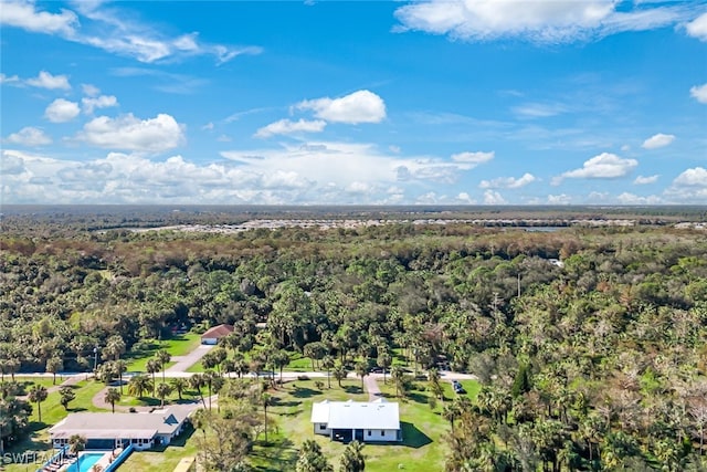 drone / aerial view with a wooded view