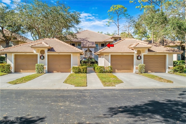 mediterranean / spanish-style house with a garage