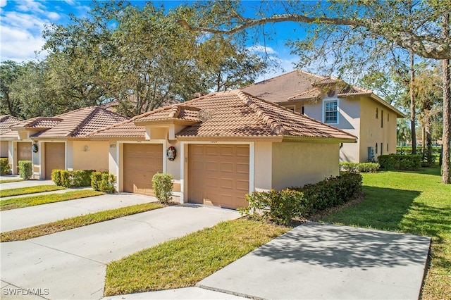 mediterranean / spanish-style house featuring a front lawn and a garage