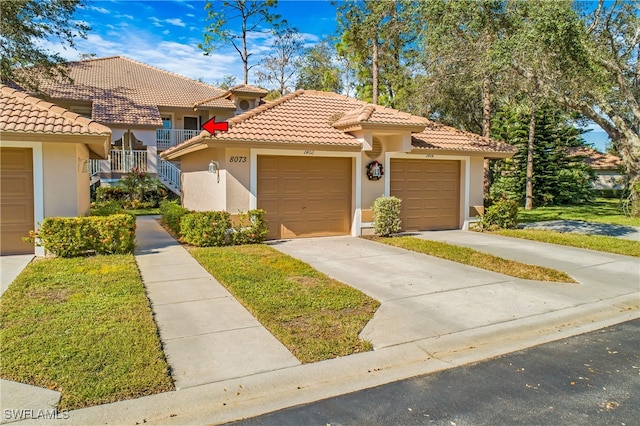 mediterranean / spanish-style house with a garage