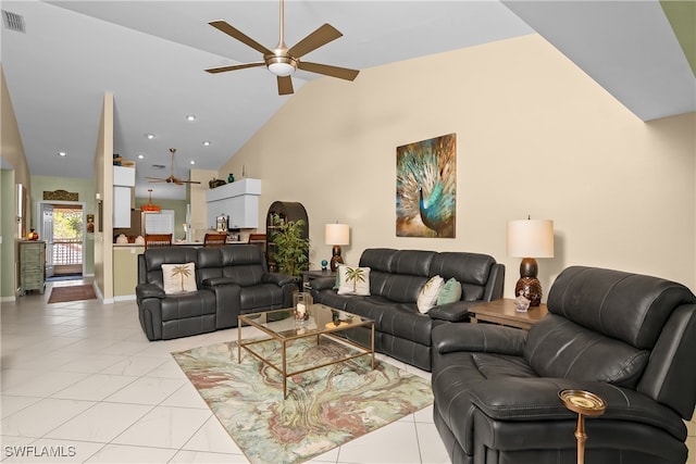 living room with ceiling fan, light tile patterned flooring, and vaulted ceiling