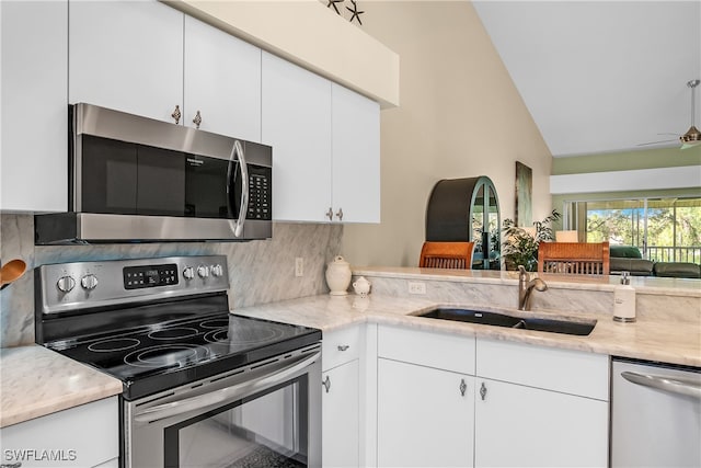 kitchen featuring decorative backsplash, white cabinetry, sink, and appliances with stainless steel finishes