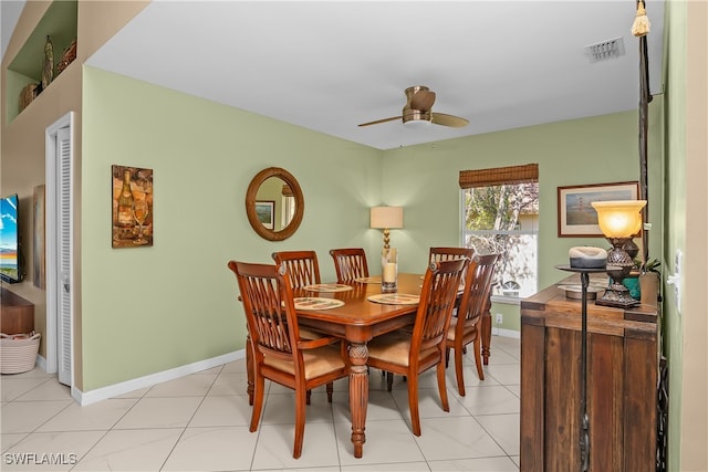 tiled dining space featuring ceiling fan