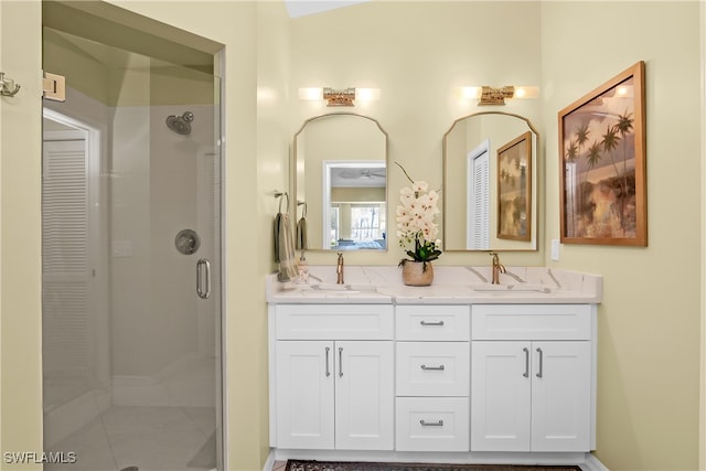 bathroom with tile patterned flooring, vanity, and a shower with door