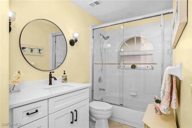 full bathroom with tile patterned floors, vanity, enclosed tub / shower combo, and toilet