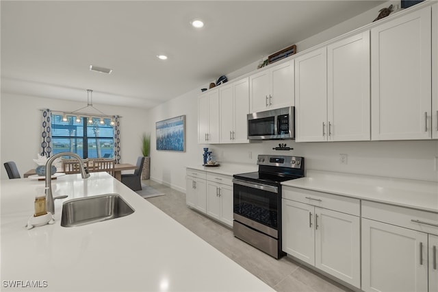 kitchen featuring white cabinets, appliances with stainless steel finishes, and sink