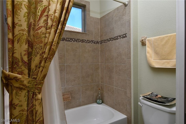 bathroom featuring shower / bath combination with curtain and toilet