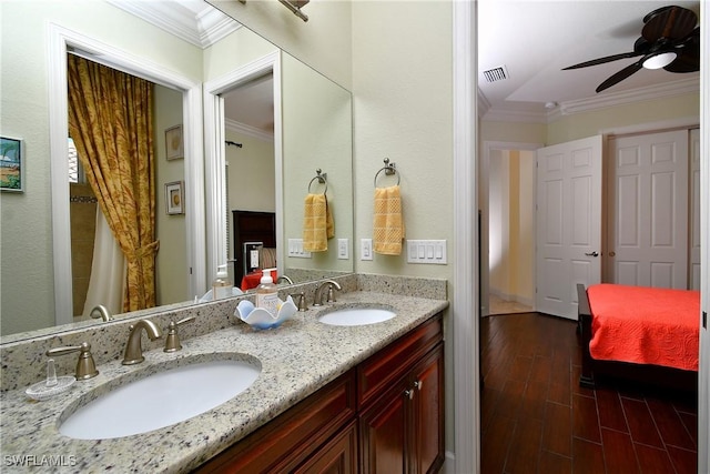 bathroom with hardwood / wood-style flooring, ceiling fan, crown molding, and vanity