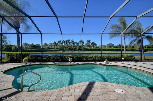 view of pool with a lanai, a water view, and a patio