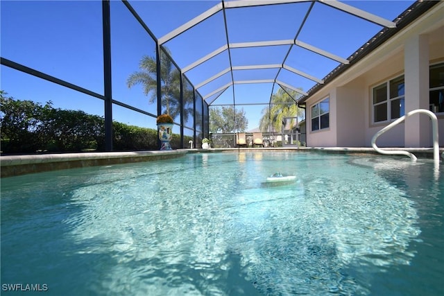 view of pool featuring glass enclosure