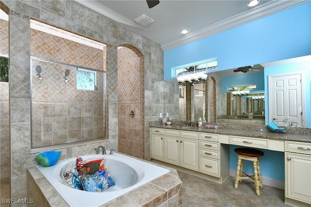 bathroom with plenty of natural light, tiled tub, crown molding, and vanity