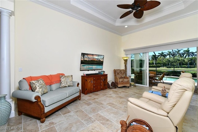 living room with ceiling fan, a raised ceiling, and crown molding