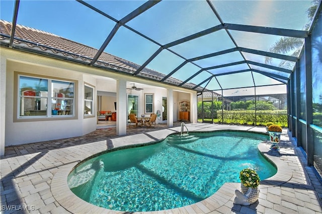 view of pool featuring a patio area, ceiling fan, and a lanai