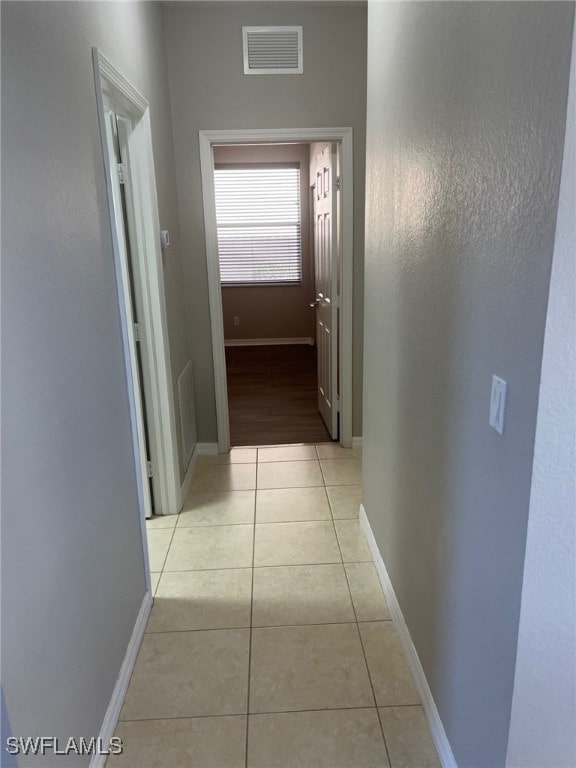 corridor featuring light tile patterned flooring