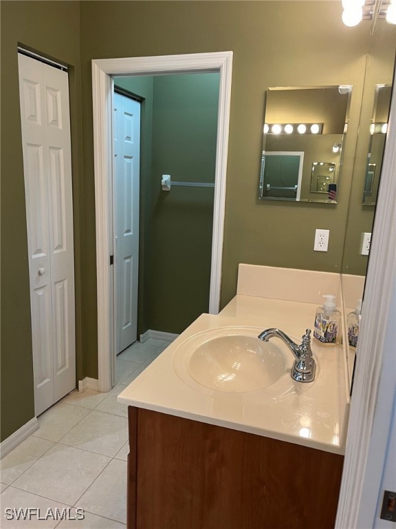 bathroom with tile patterned floors and vanity