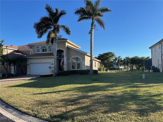 view of front of house with a garage and a front yard