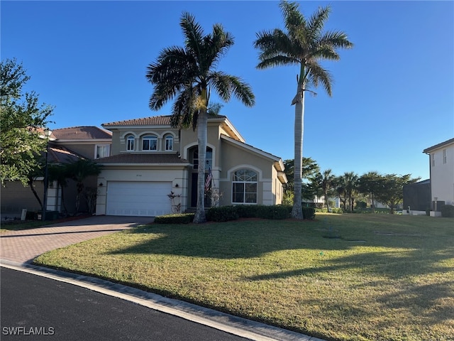 view of front facade with a garage and a front yard