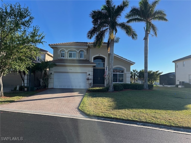 view of front of property with a front yard and a garage