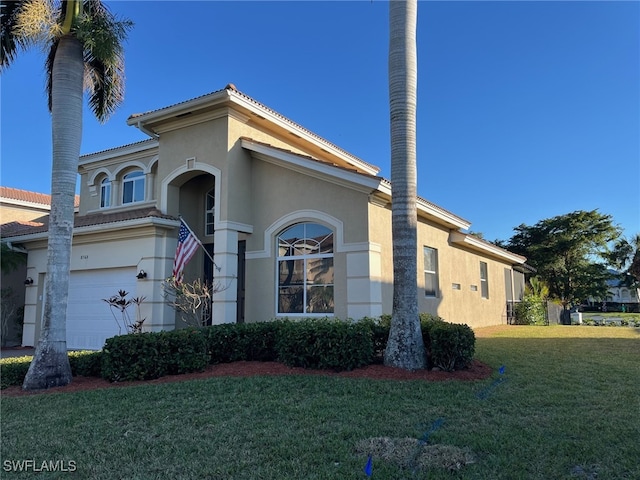 view of front of house with a front yard and a garage