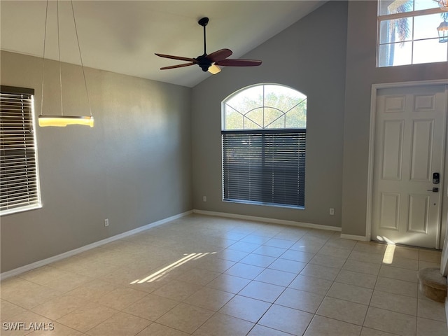 entryway featuring ceiling fan, high vaulted ceiling, and light tile patterned floors