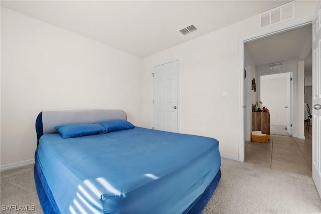 7024 Waldo Cir, Labelle, FL 33935 - bedroom featuring light carpet and light tile patterned floors