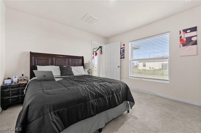 bedroom featuring light colored carpet